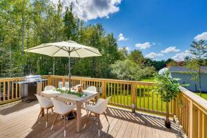 a wooden deck with a table and an umbrella at Unique Escapes - Rosé All Day Geodome in Monticello