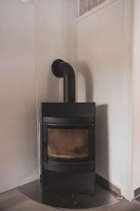 a black stove in the corner of a room at Bontveit Villa s in Bergen