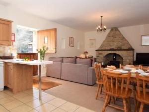 a kitchen and living room with a table and a fireplace at 2 Bed in Rowlands Gill CN192 in Stanley