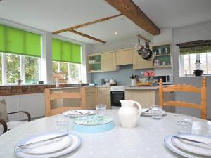 a kitchen with a table with plates on it at 3 Bed in Stratford-upon-Avon 54081 in Ettington