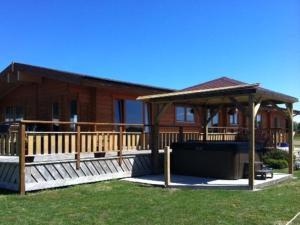 a house with a deck and a gazebo at 4 Bed in Lincoln 59449 