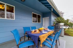 a blue house with a table and blue chairs at Pendleton House - Complimentary Wine Tasting in Walla Walla