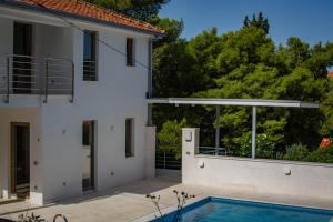 a villa with a swimming pool and a house at Villa Marumare in Milna
