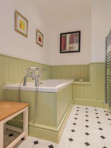 a green and white bathroom with a sink at 2 Bed in Caldbeck SZ212 in Caldbeck