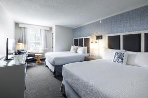 a hotel room with two beds and a television at Gravity Haus Steamboat in Steamboat Springs