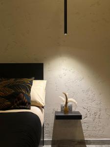 a bedroom with a bed and a table with a lamp at Falco Boutique Home with Jacuzzi in Naples