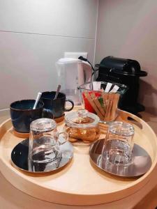 a tray with cups and dishes on a table at Residenza DV1 - Bellissimo nuovo Loft in centro in Locarno