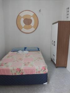 a bedroom with a bed and a dresser next to it at kitnet Cidade 2000 in Fortaleza