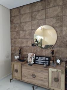 a dressing table with a mirror on a wall at شقة رائعة داخل فيلا مستقلة in Casablanca