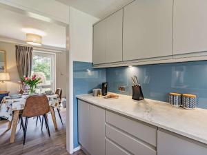 a kitchen with a counter and a dining room at 2 Bed in Keswick 87092 in Keswick