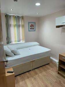 a bedroom with a large bed with a window at Leman House in London