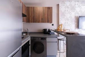 a kitchen with a washer and a dishwasher at Luxoria by SHORTSTAYCASA- New & Chic in the heart of town in Casablanca