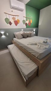 a bedroom with two beds with hearts on the wall at Flat Amarilis Apartamento 202 in Riviera de São Lourenço
