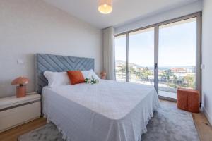 a bedroom with a bed and a large window at The King Apartment By Sam Houses in Funchal +16 photos