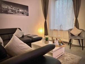 a living room with a couch and a table at G&G Luxury Apartment am Stadtpark Bendorf in Bendorf