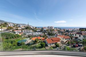 a view of a city from the balcony of a house at The King Apartment in Santo António