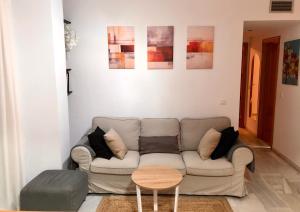 uma sala de estar com um sofá e uma mesa em La Pimentera Centro Histórico - Marbella em Marbella