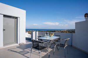 a table and chairs on a balcony with a view at E&A luxury apartment with sea view in Rhodes Town