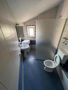 a bathroom with a toilet and a sink at Skopje&Friends Central APP in Skopje +44 photos