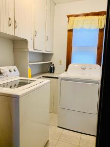 a kitchen with a stove and a dishwasher at Cozy First Floor Apartment in Chicopee