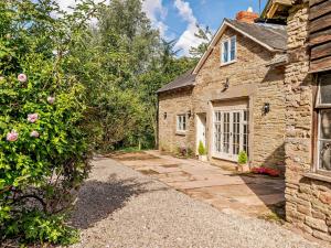 a stone house with a pathway leading to the door at 3 Bed in Leominster 93304 in Bodenham