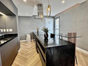 a large kitchen with a black counter top at 056 - Rentaqui Apartamento Jardim Park Side in Sao Paulo