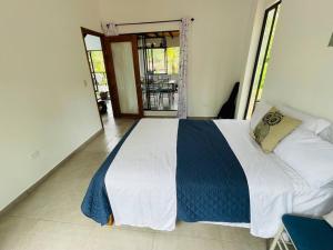 a bedroom with a large bed in a room at Chega de Saudade in Puerto Quito