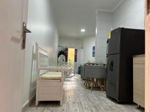 a room with a refrigerator and a table in it at Hermoso apartamento en la Ciudad Amurallada Cartagena de Indias in Cartagena de Indias