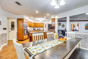 a kitchen and dining room with a table and chairs at Beautiful Hinesville Retreat with Lanai and Pool! in Hinesville