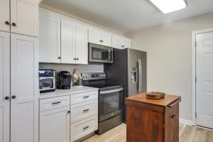 een keuken met witte kasten en een roestvrijstalen koelkast bij Charming Country Home with Deck - 20 Mi to Franklin in Columbia