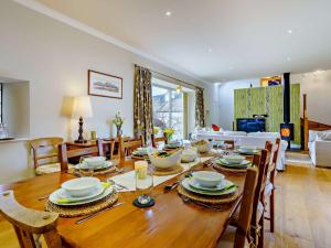 a dining room with a wooden table with chairs at 4 bed property in Moffat 82374 in Moffat