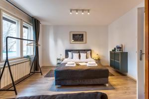 a bedroom with a bed and a large window at ZigZag Belgrade in Belgrade