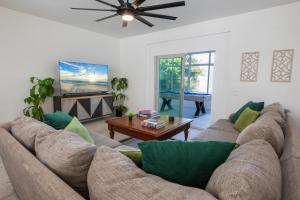 a living room with a couch and a table at Elite Retreat! Hot Tub, Arcade, & Theater. 6 Beds! in Encinitas