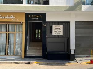 a front door of a building with a sign on it at Luxoria by SHORTSTAYCASA- New & Chic in the heart of town in Casablanca