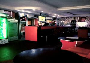 a bar with red and green lights in a room at angelaMcFadden apartment in Benin City