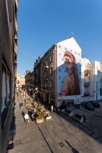 a street with a large mural on the side of a building at ZigZag Belgrade in Belgrade