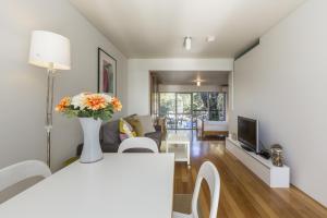 a living room with a couch and a tv at Cottesloe Tree Top Studio in Perth