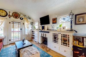 a living room with a fireplace and a tv at Desert Beauty in Phoenix