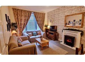 a living room with a couch and a fireplace at Entire, main door, pet friendly, home away from home, East Ayrshire in Newmilns