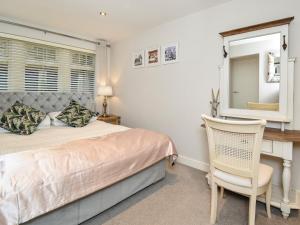 a bedroom with a bed and a desk and a chair at 1 Bed in Rothbury 88286 in Rothbury