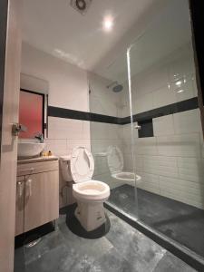 a bathroom with a toilet and a sink at Hotel Urban Cholula in Cholula