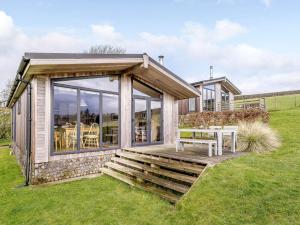 a house with a deck and a table at 2 Bed in Caldbeck 80562 in Caldbeck