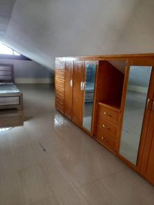 a wooden cabinet with glass doors in a room at Close to Everything in Port-of-Spain