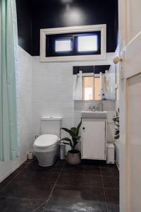 a bathroom with a toilet and a sink at Entire holiday house - Geelong - Sleeps 6 in Belmont