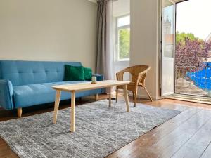 a living room with a blue couch and a table at Ady house 2 in Setúbal