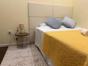 a bedroom with a bed with two pillows on it at Ady house 2 in Setúbal