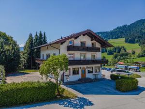 a large house with a car parked in a parking lot at Haus am Lift in Itter