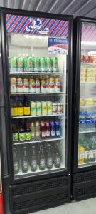 a refrigerator filled with lots of soda and drinks at Elegância Urbana, Apartamento Exclusivo, com ar in Maringá