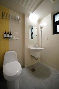 a bathroom with a white toilet and a sink at Hotel DADA Insadong in Seoul