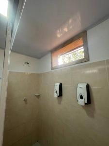 a bathroom with a shower and a window and a toilet at Inspire Country House BY JR in Providencia